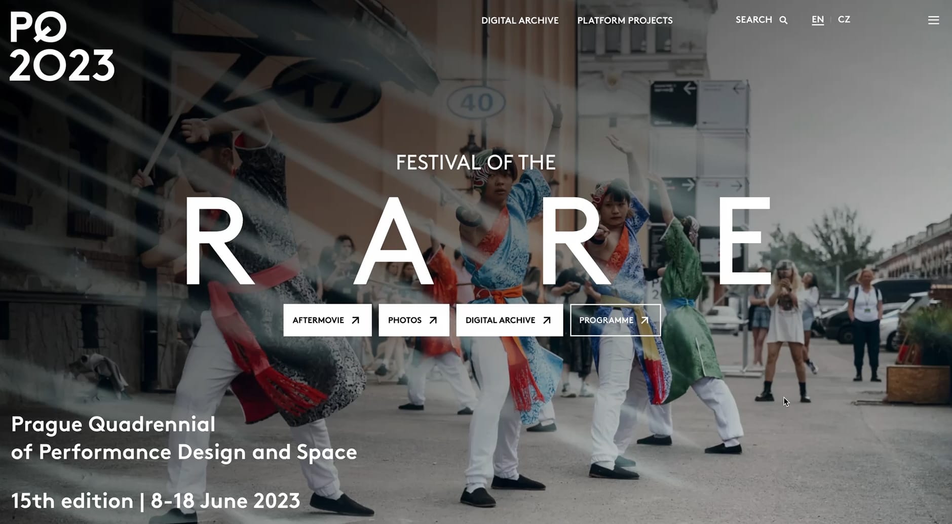 Desktop view of the PQ 2023 website homepage, with a Festival of the RARE hero over street performers.